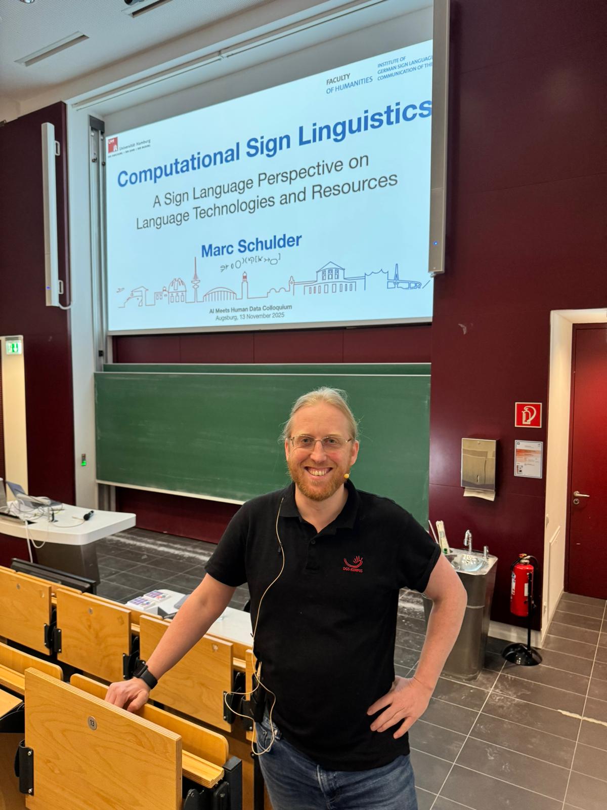 Marc Schulder standing in the Augsburg FAI auditorium